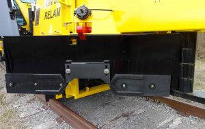 Close up view of KBR 860 plow above railway track and stone.