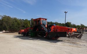KBR 925C convertible gauge equipment inu red color with green trees and blue skies in background.